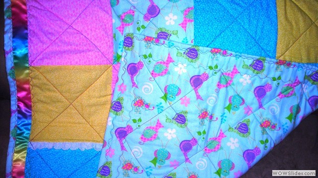 Colorful baby blanket corner view of back and front